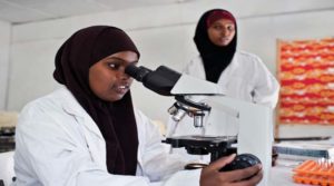 Young women study in a science laboratory at Mogadishu University, Somalia. Photo: Panos/Sven Torfinn
