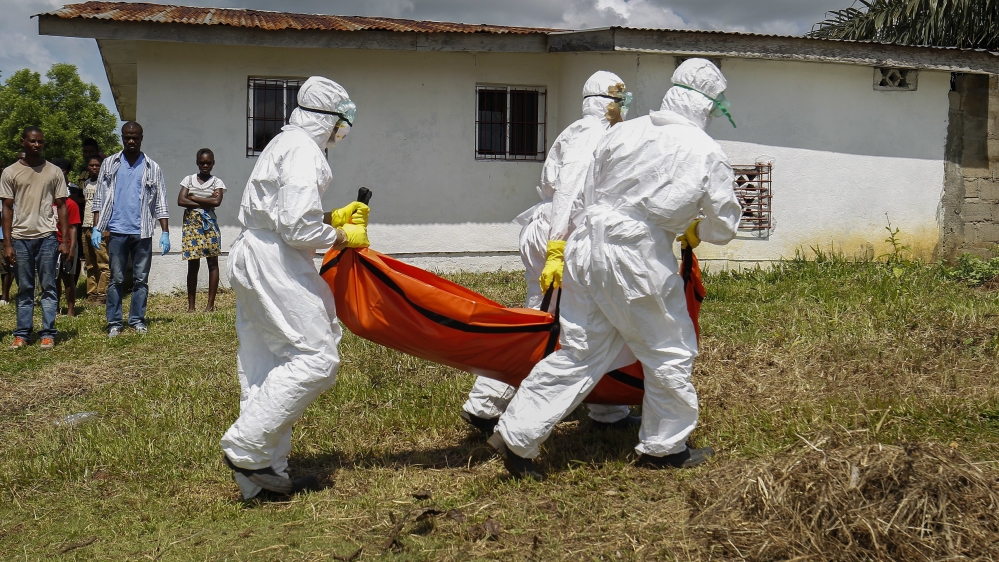 Medics carrying a corpse of Ebola victims during the latest outbreak of the diseases in DR Congo